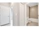 Hallway with a closed closet, a bathroom entrance, and access to other rooms at 1785 Coriander Dr, Kissimmee, FL 34759