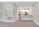 Open-concept living room showcases modern finishes, connecting to a kitchen with stainless steel appliances at 1785 Coriander Dr, Kissimmee, FL 34759