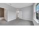 Main bedroom with gray walls, tiled floors, a window, and an ensuite bathroom at 1785 Coriander Dr, Kissimmee, FL 34759
