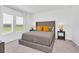Comfortable bedroom with a tufted headboard, neutral bedding, and ample natural light at 2039 Derwent Dr, Davenport, FL 33896