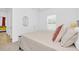 Bright bedroom with neutral bedding, a wooden bed frame, and a large window at 2039 Derwent Dr, Davenport, FL 33896