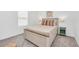 Cozy bedroom with neutral bedding, a wooden bed frame, and matching nightstands at 2039 Derwent Dr, Davenport, FL 33896