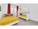 Bright bedroom with yellow bedding, Mickey Mouse themed decor, red curtains, and a white bunk bed at 2039 Derwent Dr, Davenport, FL 33896
