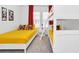 Bright bedroom with yellow bedding, Mickey Mouse themed decor, red curtains, and a white bunk bed at 2039 Derwent Dr, Davenport, FL 33896