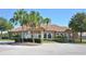 Exterior of the community clubhouse, showcasing well-manicured landscaping, ample parking, and accessible entrances at 2039 Derwent Dr, Davenport, FL 33896
