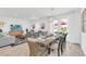 Bright dining area featuring a large table set for a meal, with an open view of the backyard at 2039 Derwent Dr, Davenport, FL 33896