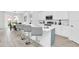 Modern kitchen with white cabinetry, stainless steel appliances, and a center island with seating at 2039 Derwent Dr, Davenport, FL 33896