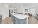 Spacious kitchen island with stainless steel appliances and a view into the living room at 2039 Derwent Dr, Davenport, FL 33896