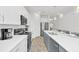 Contemporary kitchen with white cabinets, stainless appliances, and breakfast bar at 2039 Derwent Dr, Davenport, FL 33896