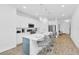 Modern kitchen boasts stainless appliances, island with seating, and bright lighting at 2039 Derwent Dr, Davenport, FL 33896