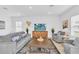 Inviting living room with comfortable sofas, a large TV, and stylish decor at 2039 Derwent Dr, Davenport, FL 33896