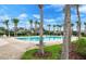 A stunning community pool is surrounded by beautiful palm trees and comfortable lounge chairs for relaxing in the sun at 2039 Derwent Dr, Davenport, FL 33896