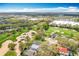 Aerial view of community with golf course, lush landscaping, nearby shopping, and recreation at 2105 Mallory Cir, Haines City, FL 33844