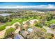 Aerial view showcasing the golf course community and houses with screened-in pools at 2105 Mallory Cir, Haines City, FL 33844