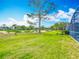 Spacious backyard features green grass and a view of the nearby golf course at 2105 Mallory Cir, Haines City, FL 33844