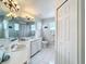 Bright bathroom featuring a double vanity, tile floors, and a shower at 2105 Mallory Cir, Haines City, FL 33844