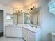 Bathroom featuring a double vanity, tile floors, and plenty of cabinet space at 2105 Mallory Cir, Haines City, FL 33844