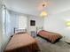 Bedroom features two twin beds, carpeted floors, a ceiling light, and a light gray paint color at 2105 Mallory Cir, Haines City, FL 33844