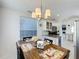 Bright dining area with wood table, decorative chandelier, and view to the kitchen with granite counters at 2105 Mallory Cir, Haines City, FL 33844