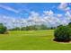 Scenic view of the golf course showing manicured green, sand traps and blue sky at 2105 Mallory Cir, Haines City, FL 33844