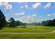 Scenic view of the golf course showing manicured green, sand traps and blue sky at 2105 Mallory Cir, Haines City, FL 33844
