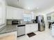 Bright kitchen featuring stainless steel appliances, granite counters, and white cabinets with ample storage at 2105 Mallory Cir, Haines City, FL 33844