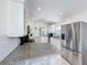 Modern kitchen features stainless steel appliances, granite countertops, and bright white cabinets at 2105 Mallory Cir, Haines City, FL 33844