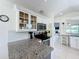 Granite counters complement white cabinets, with stainless steel appliances in this well-lit kitchen at 2105 Mallory Cir, Haines City, FL 33844