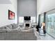 Bright living room featuring soaring ceilings, a fireplace, and a cozy sectional sofa at 2105 Mallory Cir, Haines City, FL 33844