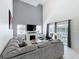 Open living room featuring a fireplace, large grey sofa and access to the outdoor space at 2105 Mallory Cir, Haines City, FL 33844