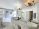 Bright ensuite bathroom featuring double sinks, vanity and jacuzzi bathtub at 2105 Mallory Cir, Haines City, FL 33844