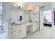Ensuite bathroom featuring double sinks, generous counter space, and bathtub at 2105 Mallory Cir, Haines City, FL 33844