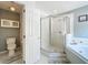 Ensuite bathroom features a separate toilet, bathtub and glass enclosed shower at 2105 Mallory Cir, Haines City, FL 33844