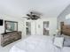 Bright main bedroom with ensuite bathroom access, fan and large dresser at 2105 Mallory Cir, Haines City, FL 33844