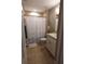 Bright bathroom featuring tile flooring, single sink vanity, and shower with decorative floral curtain at 214 Kay St, Auburndale, FL 33823