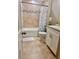 Well-lit bathroom featuring a shower-tub combo, modern vanity, and ceramic tile flooring at 214 Kay St, Auburndale, FL 33823