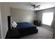 Cozy bedroom with neutral color scheme, ceiling fan, and plush carpeting at 214 Kay St, Auburndale, FL 33823