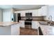 Modern kitchen with stainless steel appliances, granite countertops, and white cabinetry at 214 Kay St, Auburndale, FL 33823