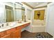 Bathroom boasts double sinks and a soaking tub with decor at 215 Cordova Ave, Davenport, FL 33897