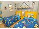 Bedroom features two beds, Minion themed decorations and a window at 215 Cordova Ave, Davenport, FL 33897