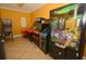 Arcade games offer a fun and entertaining experience in this home's dedicated game room at 215 Cordova Ave, Davenport, FL 33897