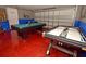Bright game room featuring a pool table, air hockey, and red epoxy floor at 215 Cordova Ave, Davenport, FL 33897