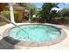 Relaxing community hot tub with clear water and lush landscaping around it at 215 Cordova Ave, Davenport, FL 33897