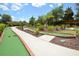 Fun mini golf course surrounded by trees, greenery, and paved pathways at 215 Cordova Ave, Davenport, FL 33897