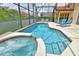 Inviting screened-in pool area with a heated pool and spa, perfect for relaxation and entertaining at 215 Cordova Ave, Davenport, FL 33897