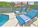 Inviting poolside lounge area with comfortable blue chairs and nearby jacuzzi at 215 Cordova Ave, Davenport, FL 33897