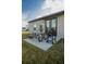 Backyard featuring modern outdoor furniture and grill on concrete patio at 2166 Derwent Dr, Davenport, FL 33896