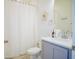 Bright bathroom features floral accents, shower with curtain, and modern fixtures at 2166 Derwent Dr, Davenport, FL 33896