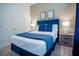 Bright bedroom showcases a comfortable bed with bedside tables, artwork, and soft carpet flooring for a relaxing space at 2166 Derwent Dr, Davenport, FL 33896