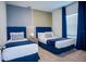 A cozy bedroom features two comfortable beds with soft carpet, offering a relaxing and inviting retreat at 2166 Derwent Dr, Davenport, FL 33896